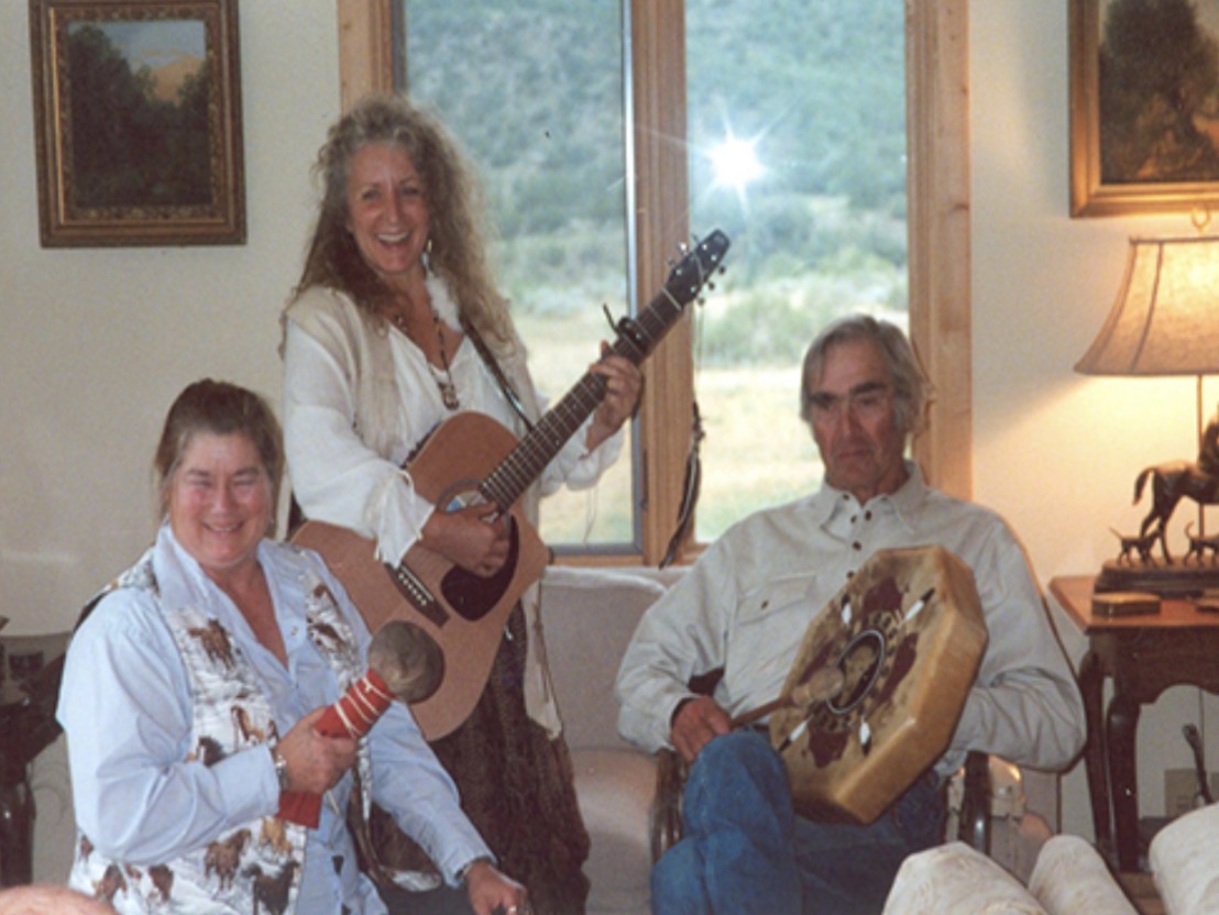 Bunny playing guitar with friends during a jam session with a drum